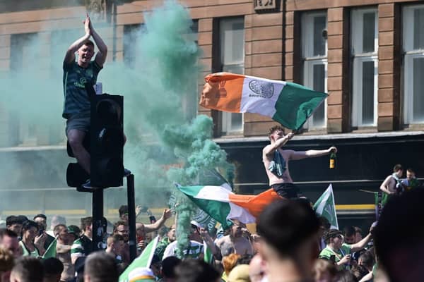 Two police officers were injured in Glasgow city centre after Celtic beat Hearts 3-1 to dramatically win the league title on the last match of the season.