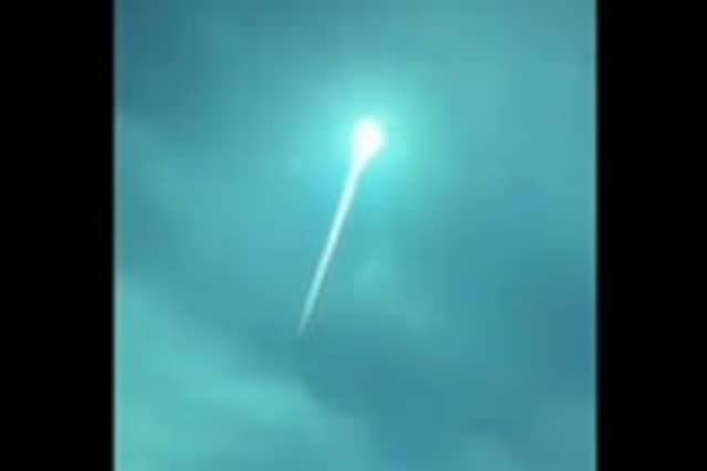Blue fireball shoots across night sky in Europe.