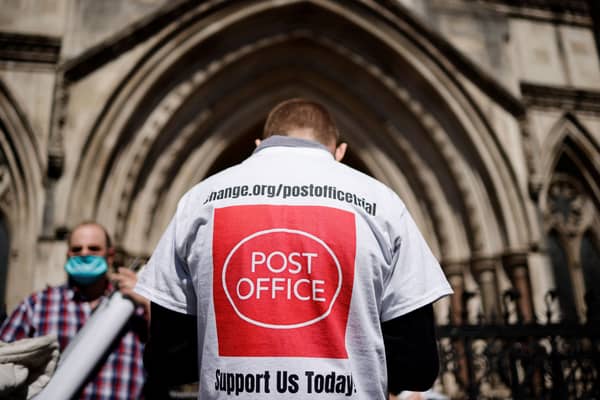 A supporter celebrates outside the Royal Courts of Justice in London following a court ruling clearing sub-postmasters of convictions for theft and false accounting. Picture: Tolga Akmen/AFP via Getty Images