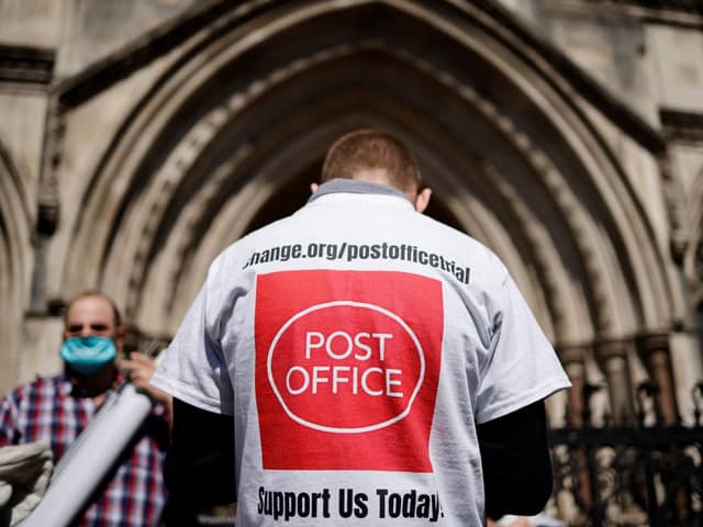 A supporter celebrates outside the Royal Courts of Justice in London following a court ruling clearing sub-postmasters of convictions for theft and false accounting. Picture: Tolga Akmen/AFP via Getty Images