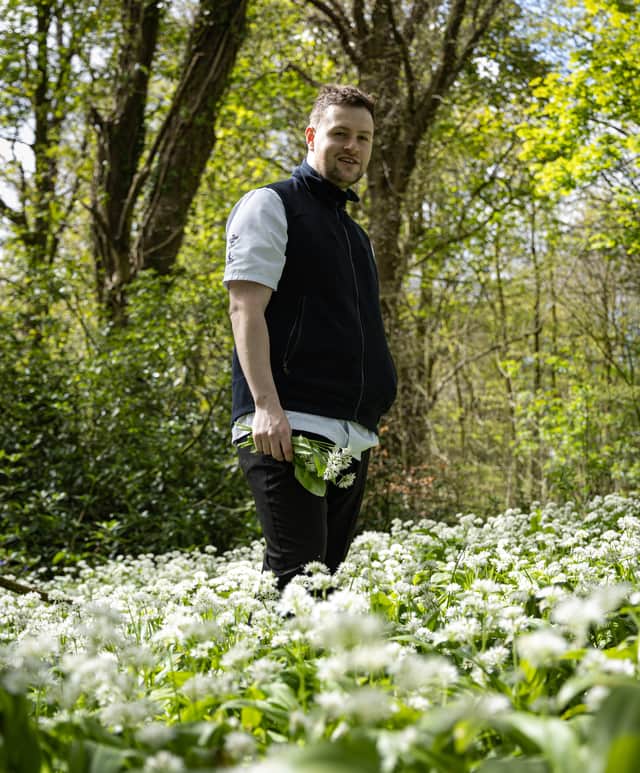 Chef Fraser Cameron picking wild herbs and edible flowers at Comlongon Estate