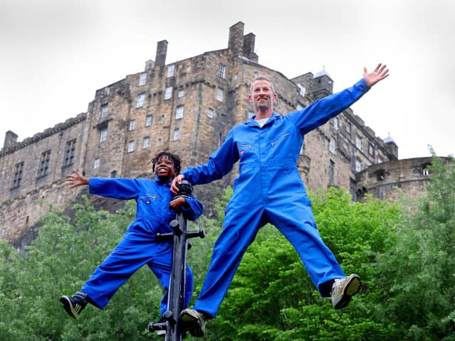 Performers Robbie Synge and Alfie, 10, from dance show The Show for Young Men perform against the backdrop of the Edinburgh Castle. Picture: Colin Hattersley Photography/Federation of Scottish Theatre