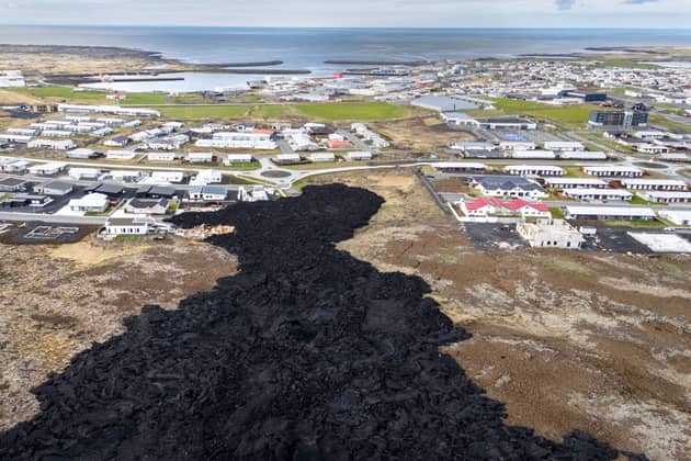 Cooled lava reaches the outskirts of a on evacuated fishing town on May 23, 2024, at Grindavik, Iceland. There have been a series of eruptions in the country's Reykjanes Peninsula since last autumn, causing extensive damage and the evacuation of the town of Grindavik. (Photo by John Moore/Getty Images)