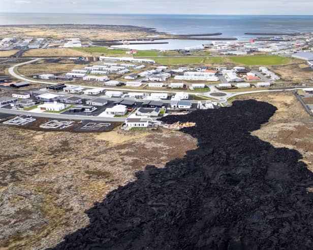 Cooled lava reaches the outskirts of a on evacuated fishing town on May 23, 2024, at Grindavik, Iceland. There have been a series of eruptions in the country's Reykjanes Peninsula since last autumn, causing extensive damage and the evacuation of the town of Grindavik. (Photo by John Moore/Getty Images)