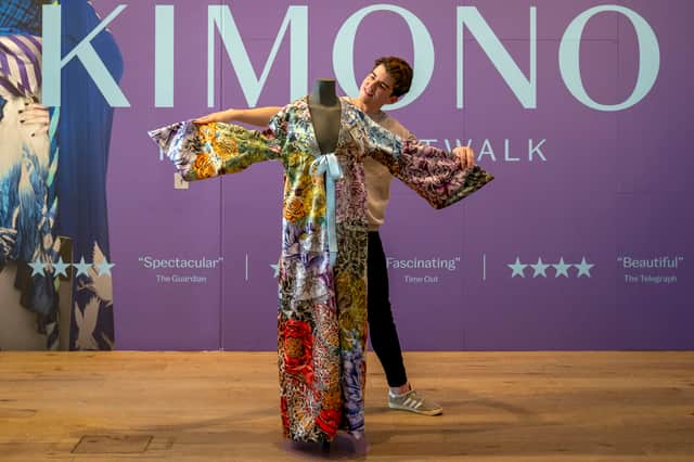 Museum content manager Chris Keatch takes a closer look at a kimono inspired by Taylor Swift's music on display in the Kimono: Kyoto to Catwalk exhibition at the V&A in Dundee, ahead of The Eras Tour opening in Edinburgh.