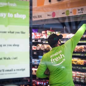 A member of staff refills the shelves in the UK's first branch of Amazon Fresh