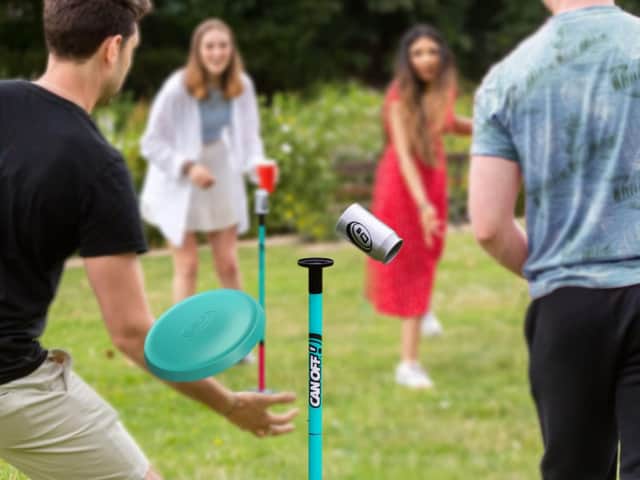 Knock the cans off the poles with small frisbees