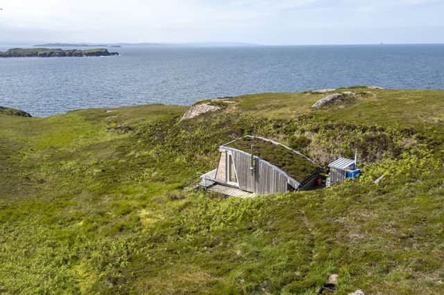 The heather topped cabin looks out to sea