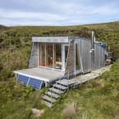 The tiny cabin is clad in larch
