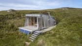 The tiny cabin is clad in larch