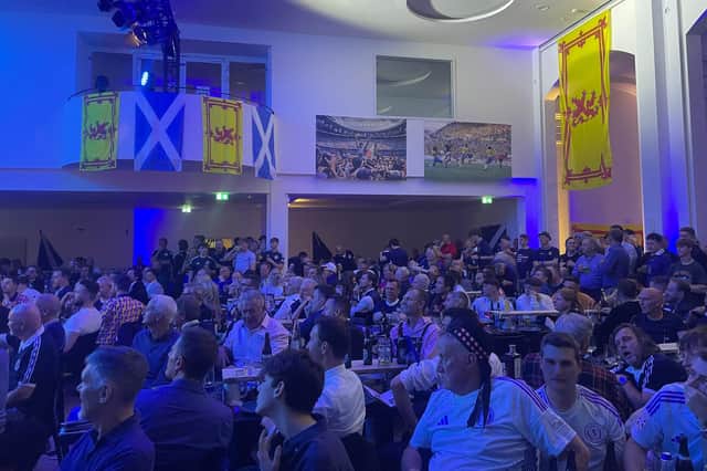 Scotland fans take in the party at an old post office in Munich.