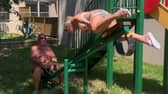 Grandmother flips over the handlebars of seesaw on holiday.