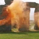 A screen grab taken from a handout video of Just Stop Oil protesters spraying an orange substance on Stonehenge
