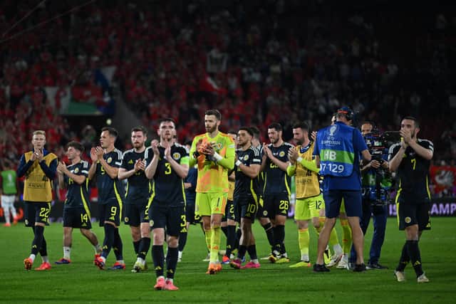 Scotland's players applaud fans on the pitch after the draw against Switzerland.