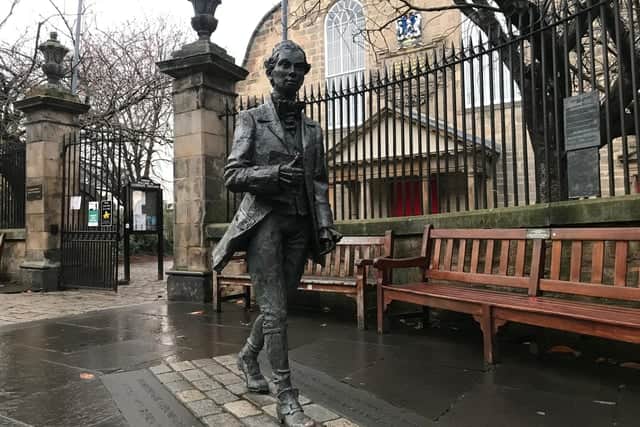 The statue of Robert Fergusson outside his resting place at Canongate Kirk in Edinburgh