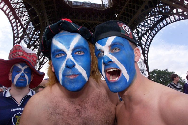 Three Scotland fans take in the Eiffel Tower in Paris.