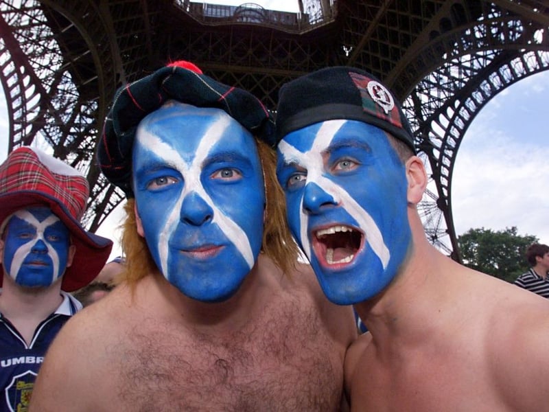 Three Scotland fans take in the Eiffel Tower in Paris.