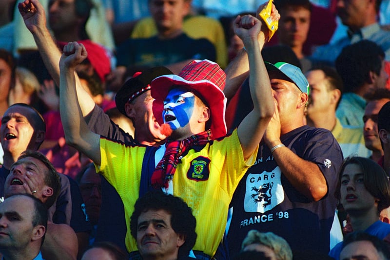 A Scotland fan with his face painted cheers the team on against Morocco.