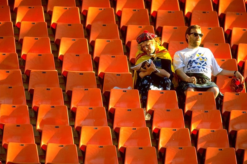 Two Scotland fans soak up the sun ahead of the game with Morocco.