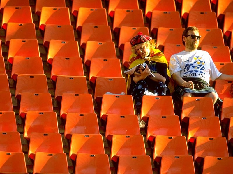 Two Scotland fans soak up the sun ahead of the game with Morocco.