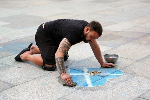 A Scotland fan draws a Scottish saltire love heart outside Cologne Cathedral.