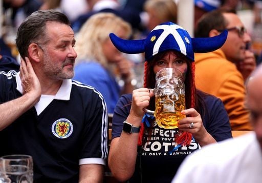 A Scottish fan enjoys a stein in the Marienplatz, Munich.