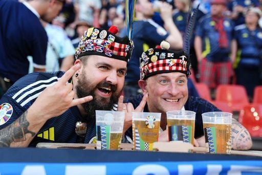 These two Scotland fans enjoy a pint at the Cologne Arena.