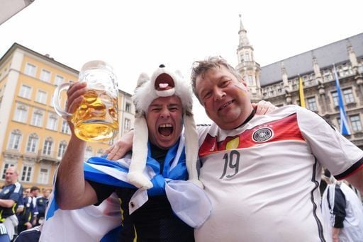 Scotland fans share a drink with German fans ahead of the Euro 2024 opener.