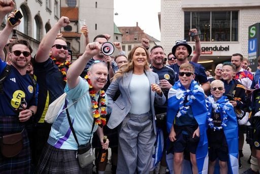 Scotland fans mingle with TV presenter Laura Woods ahead of the game with Germany.