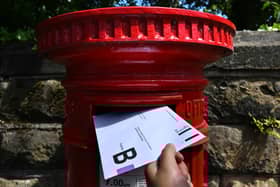 An envelope containing a Postal Vote for the upcoming UK General Election is posted.