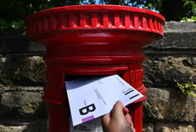 An envelope containing a Postal Vote for the upcoming UK General Election is posted.
