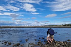 Taking off socks and shoes at the estuary near Cramond Island, oblivious to what was to come 