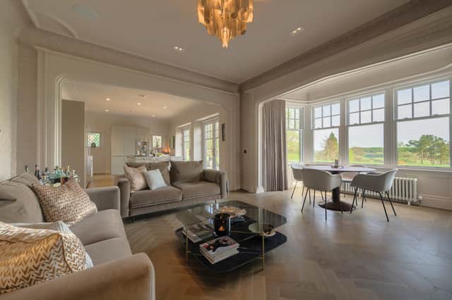 The kitchen now opens out to a seating area, via an arch which matches that of the bay window