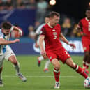 Alistair Johnston of Canada drives the ball against Julian Alvarez of Argentina. Cr: Getty Images