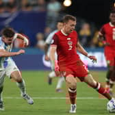 Alistair Johnston of Canada drives the ball against Julian Alvarez of Argentina. Cr: Getty Images