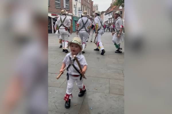 Two-year-old Toby dances along with father’s Morris dance group.
