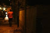 A lone woman hurries on her way along streets that no longer feel safe for many (Picture: Chris Young/AFP via Getty Images)