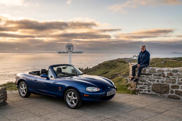 Jim McGill at Land’s End next to a second generation Mazda MX-5. Credit: David Smith