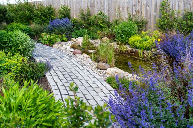 Ponds and natural stone paving form the basis for planting