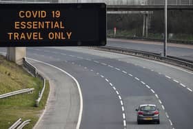A motorway sign on the M8 motorway warns only essential travel is allowed in the early days of lockdown in March 2020 (Picture: Jeff J Mitchell/Getty Images)
