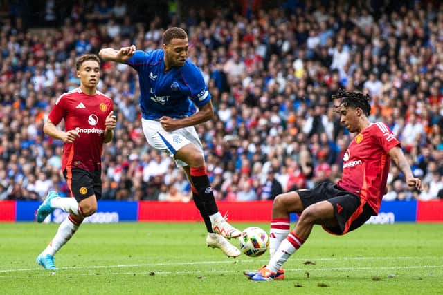 New Man Utd defender Leny Yoro blocks an effort from Cyriel Dessers.