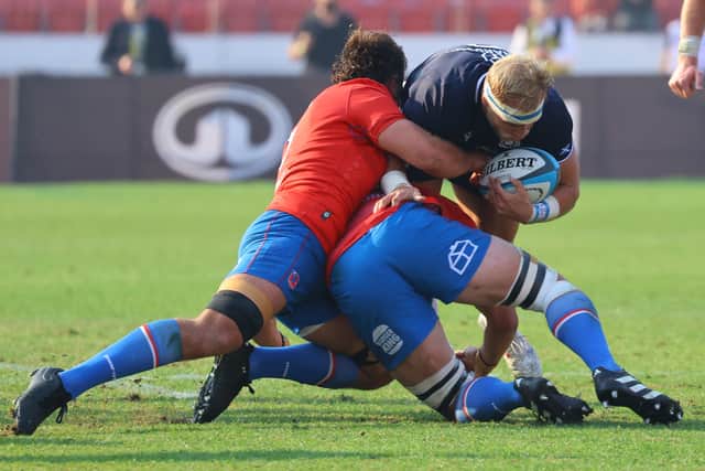 The Chileans get to grips with Dylan Richardson.