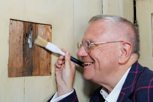Jacobite historian Professor Murray Pittock, of the University of Glasgow, next to the musket ball hole