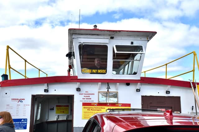 Ferry operator Dougie Robertson steering the vessel.