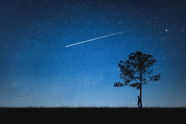 The unmistakable sight of a shooting star lighting up the night sky.