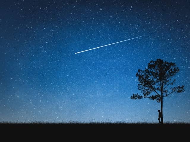 The unmistakable sight of a shooting star lighting up the night sky.