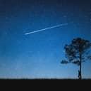The unmistakable sight of a shooting star lighting up the night sky.