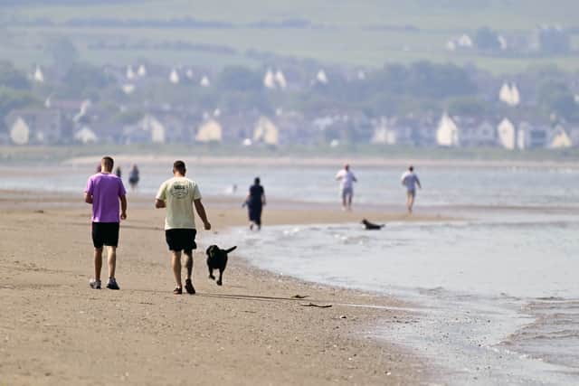 People stroll along Ayr beach (Picture: John Devlin)