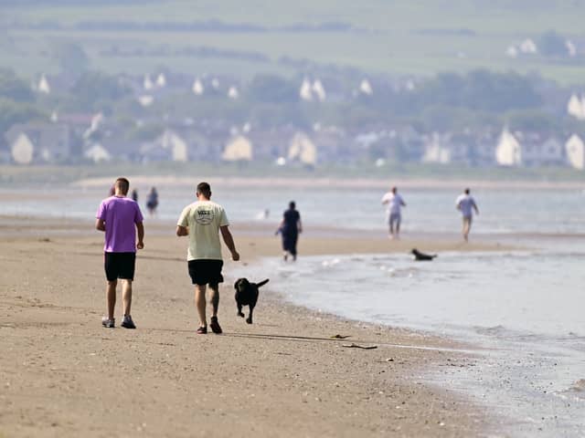 People stroll along Ayr beach (Picture: John Devlin)