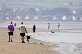 People stroll along Ayr beach (Picture: John Devlin)